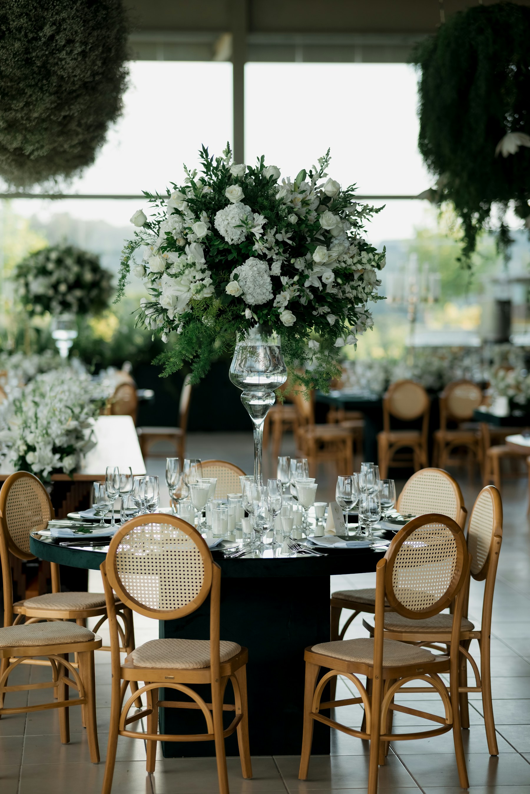 An elegant event table with white flowers and carefully arranged place settings